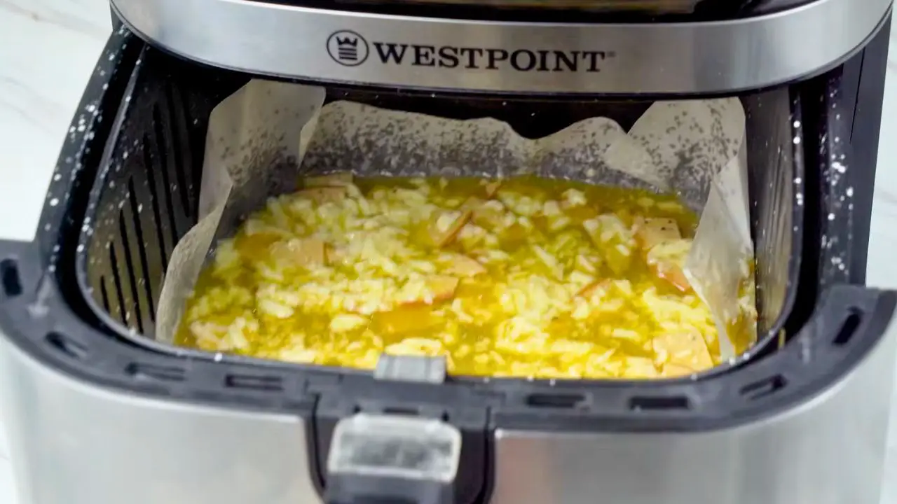Air fryer omelet cooking in the basket until the eggs are set and the cheese is melted.