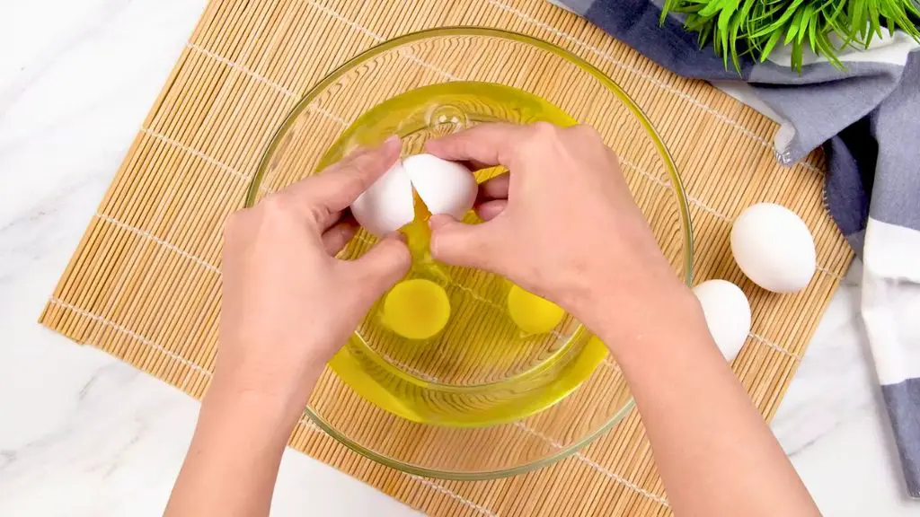 Carefully crack the eggs into the water one at a time for air fryer poached eggs, keeping them close to the surface so the yolks stay whole.