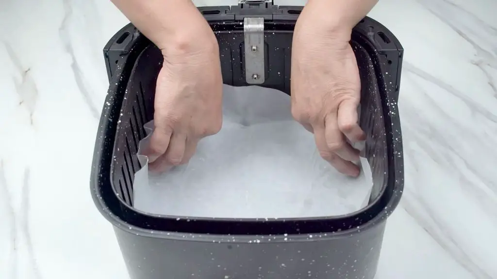 Line the basket with parchment paper before adding your air fryer pizza so it is easier to lift out once cooked and makes cleanup much simpler.