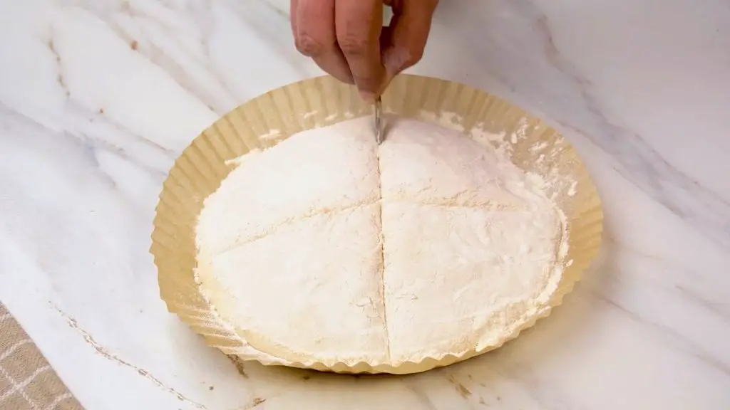 Scoring the top of this no-knead bread helps the dough expand as it bakes.
