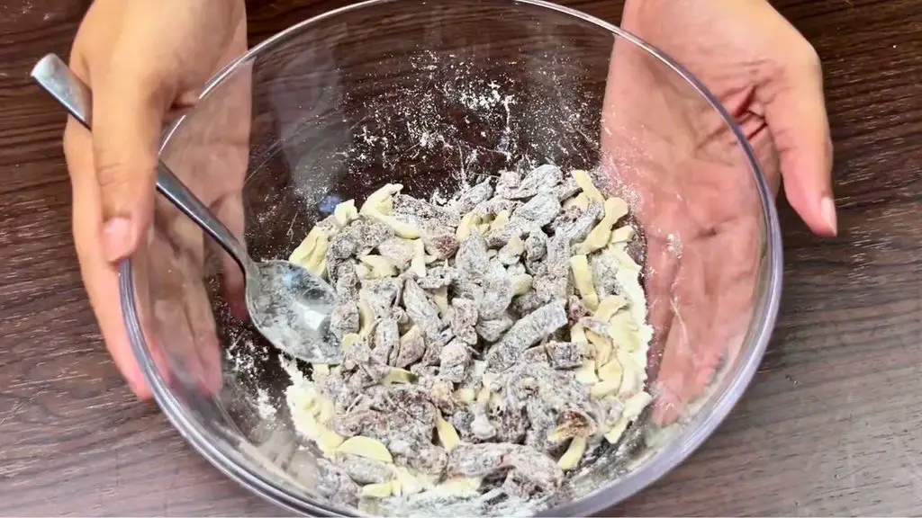 Chopped dates and cashews lightly coated with flour for a carrot and date cake recipe.